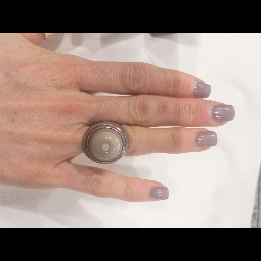 Sterling silver ring with a circular tan center.